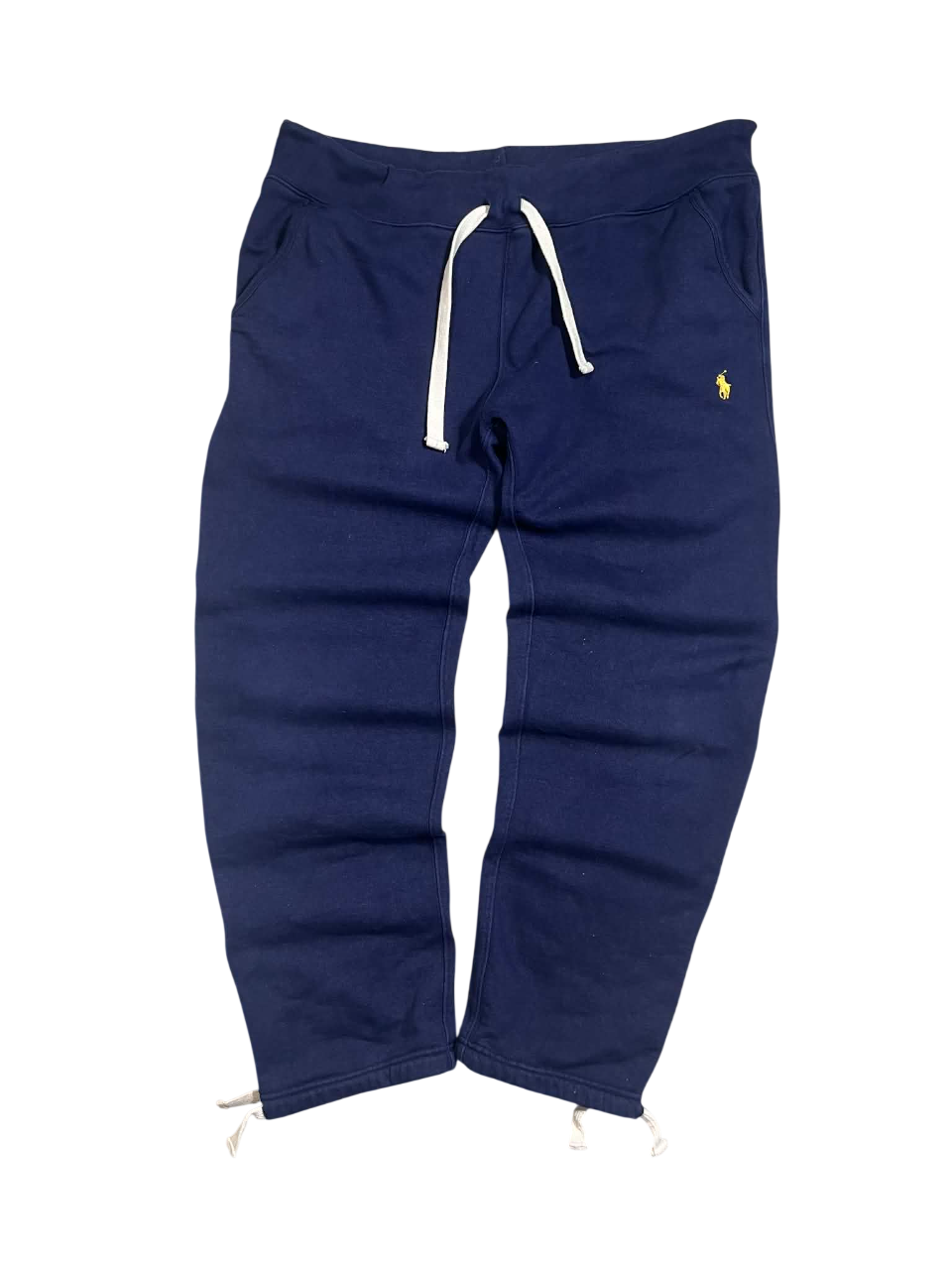 Sötétkék férfi melegítőnadrág, oldalzsebekkel, fehér húzózsinórokkal, hímzett logóval